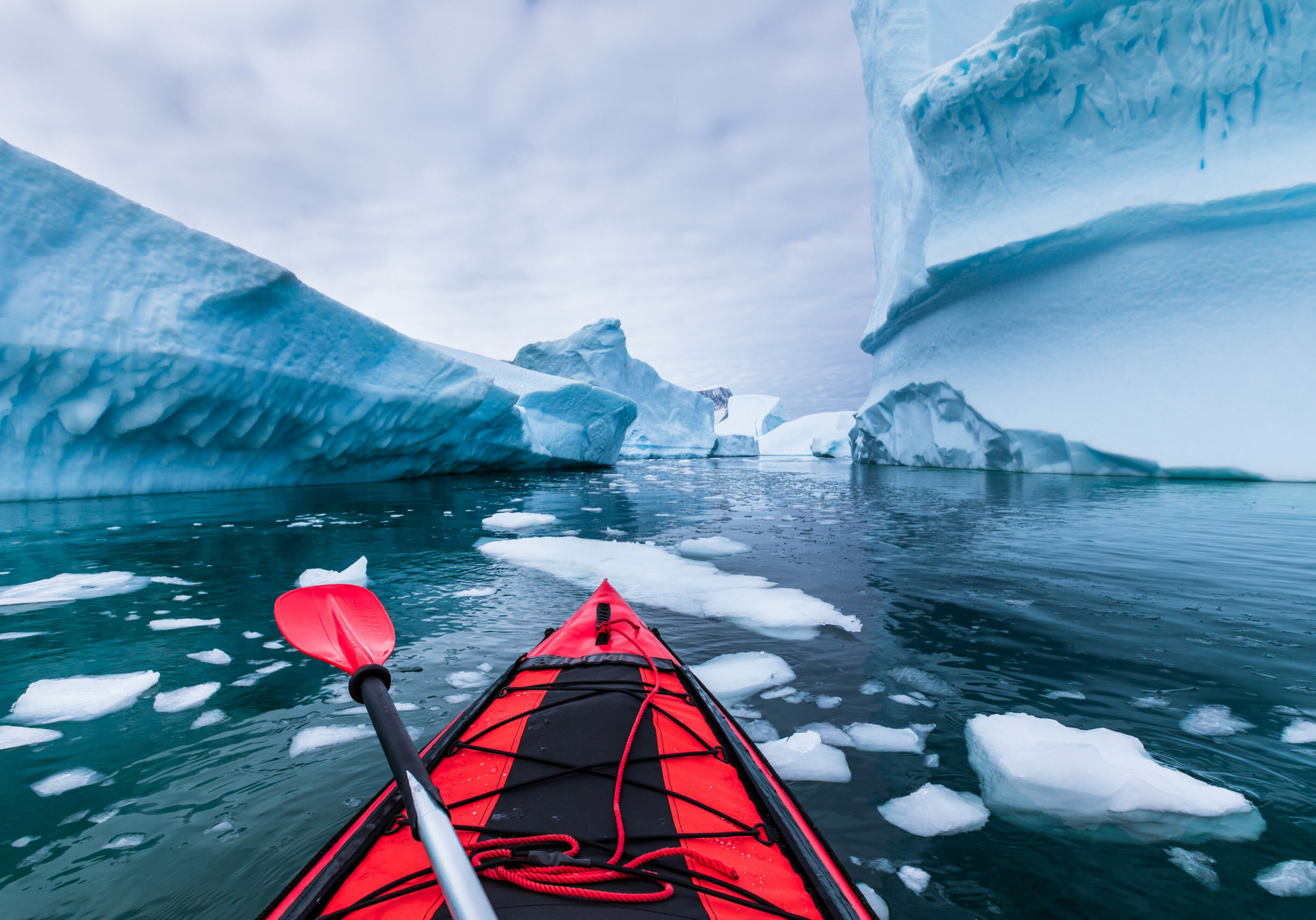 Kayaking in Antarctica between icebergs with inflatable kayak, extreme adventure in Antarctic Peninsula , beautiful pristine landscape, sea water paddling activity Kayaking in Antarctica between icebergs with inflatable kayak, extreme adventure in Antarctic Peninsula , beautiful pristine landscape, sea water paddling activity